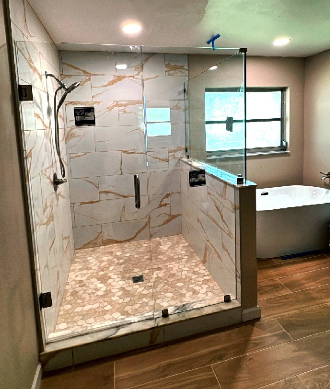Walk-in frameless shower with marble