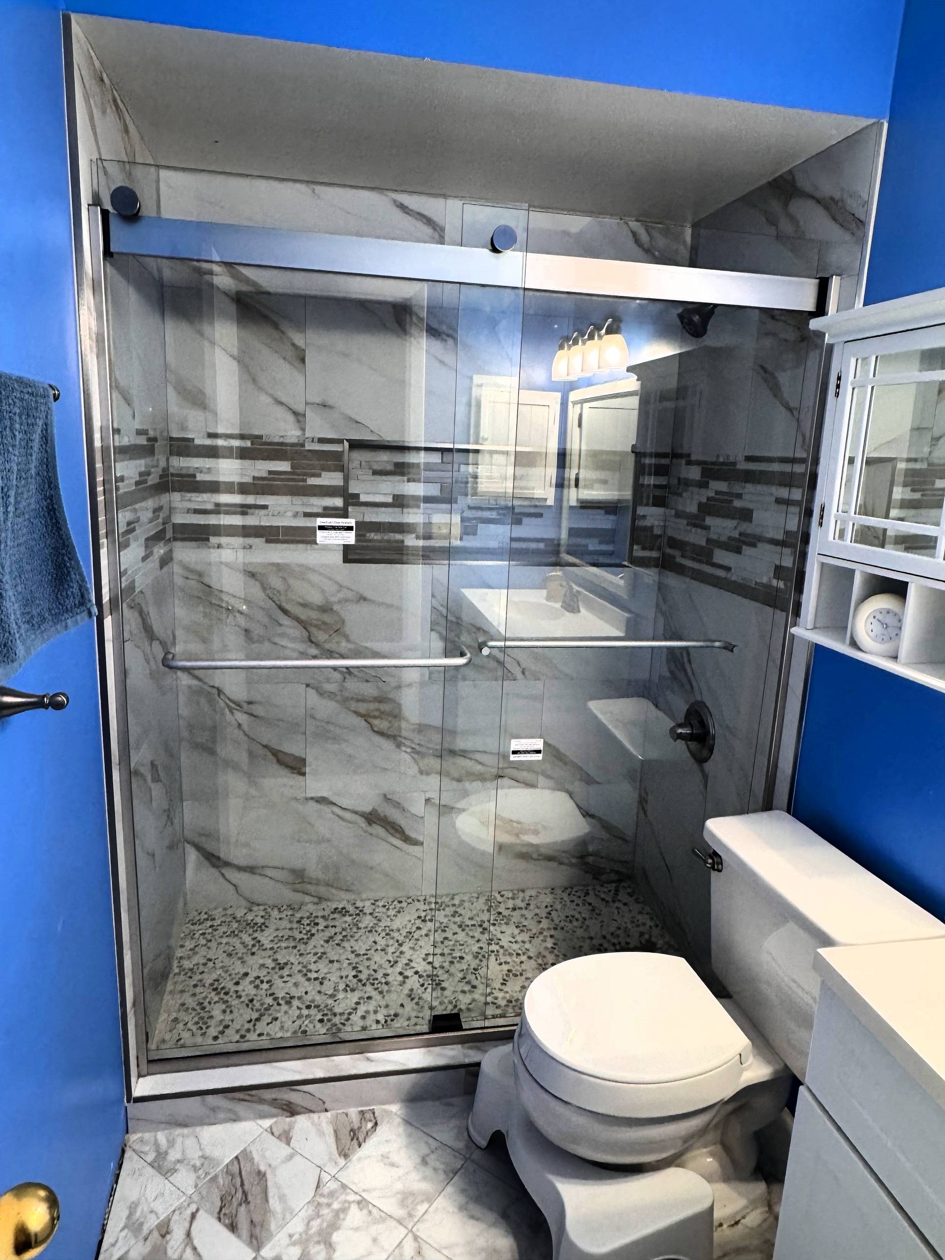 Sliding frameless shower door